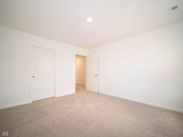 unfurnished bedroom with recessed lighting, baseboards, visible vents, and light colored carpet