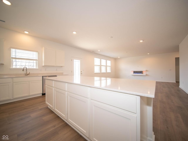 kitchen featuring recessed lighting, a healthy amount of sunlight, a sink, and dishwasher