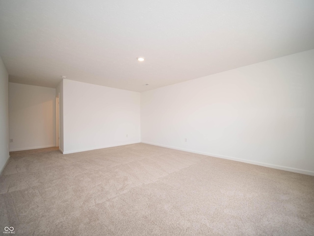 empty room with recessed lighting, light carpet, and baseboards