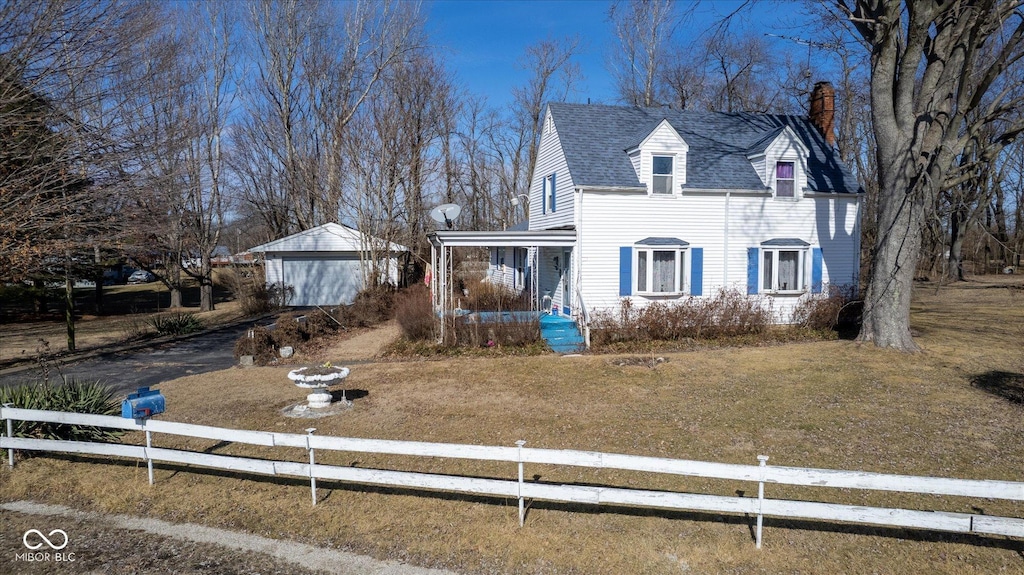 view of front of house with a porch, an outdoor structure, and a front yard