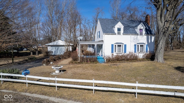 view of front of house with a porch, an outdoor structure, and a front yard