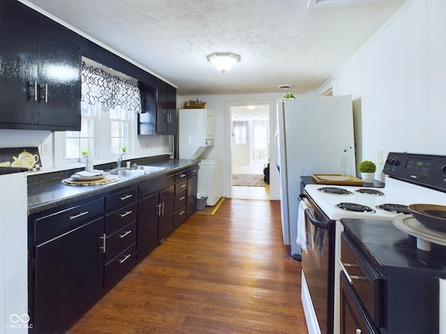 kitchen with sink, dark wood-type flooring, range with electric stovetop, ornamental molding, and a textured ceiling