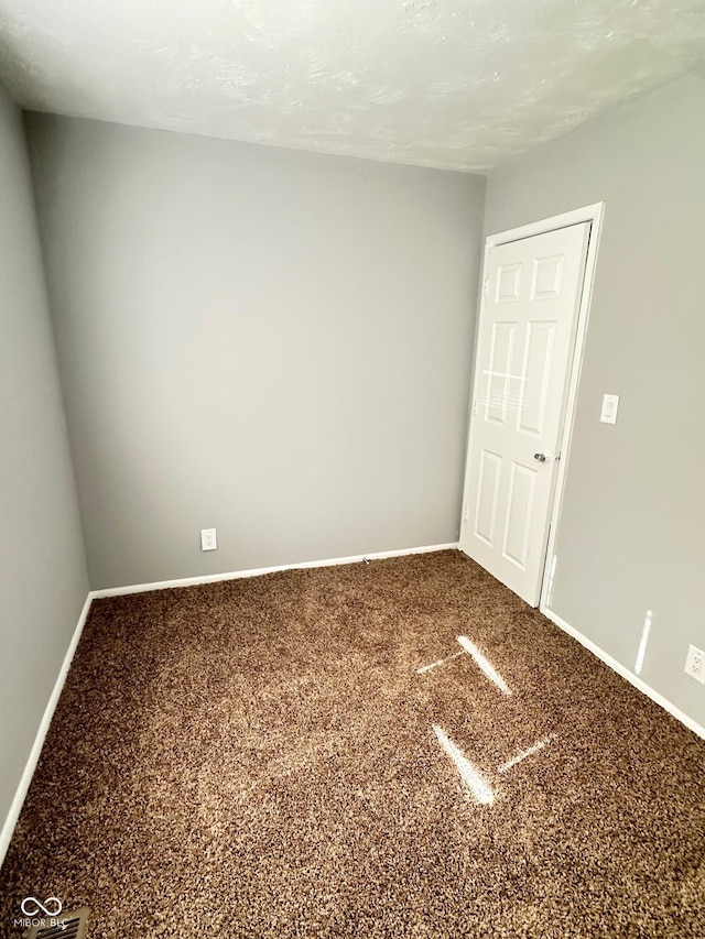 unfurnished room featuring carpet