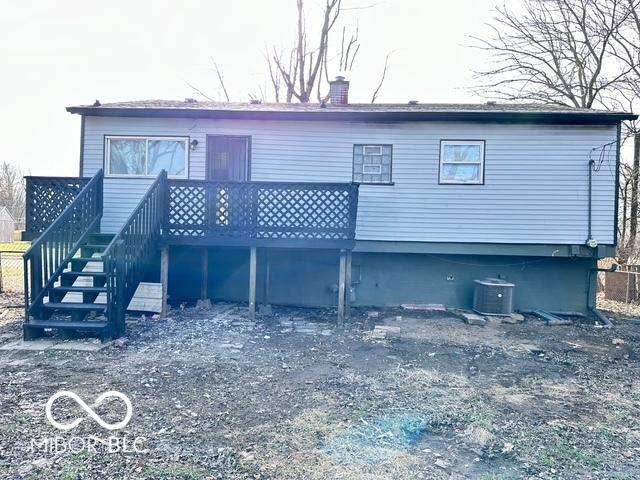 rear view of house featuring a deck and central air condition unit