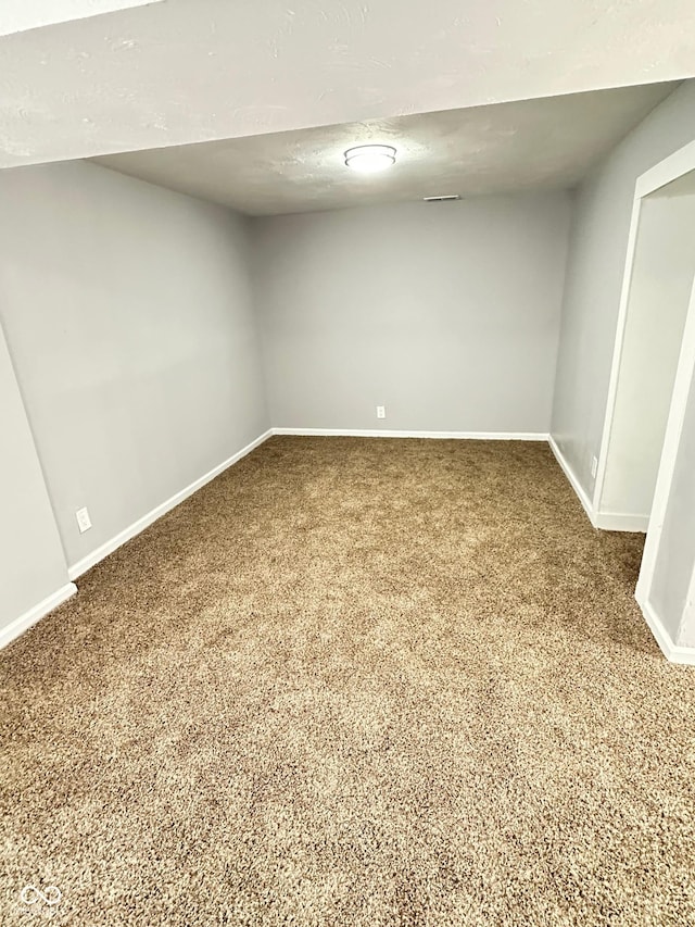 carpeted spare room featuring a textured ceiling