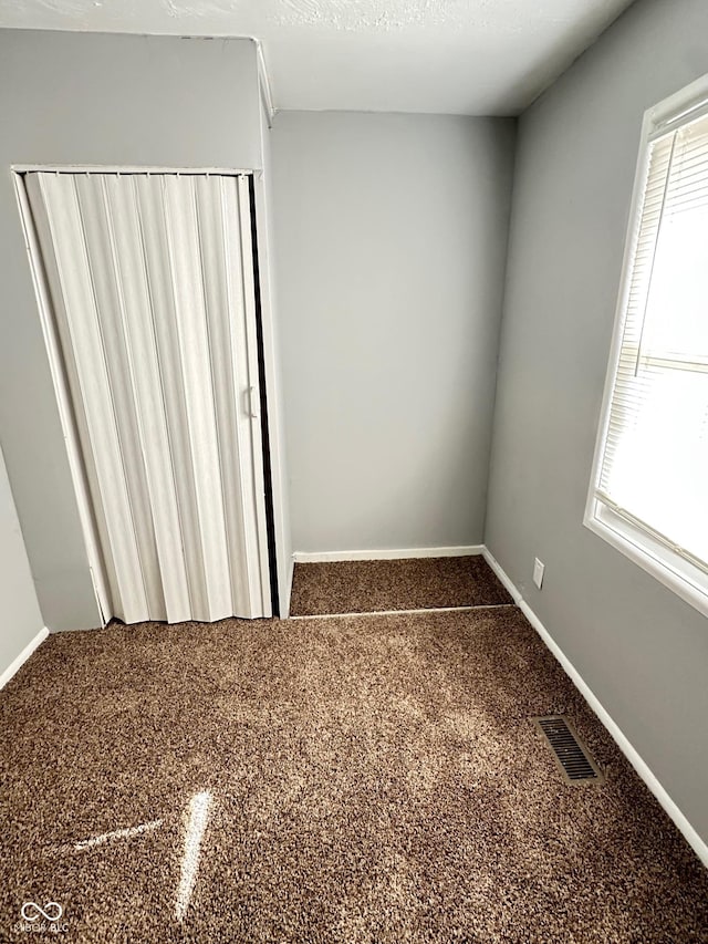 interior space with plenty of natural light and carpet flooring