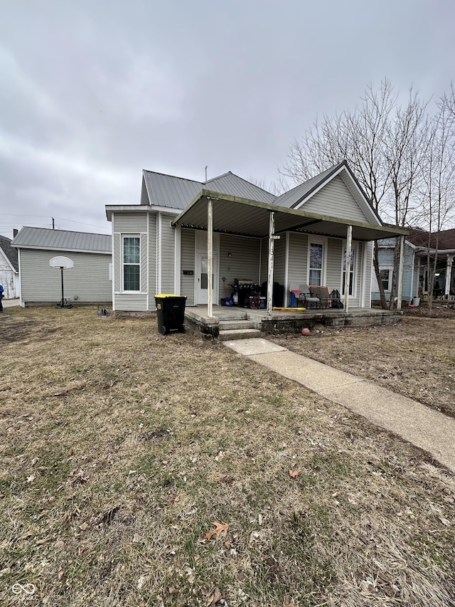 view of front of home with a porch and a front yard