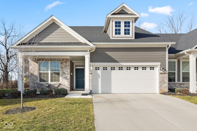 craftsman house with a garage and a front yard