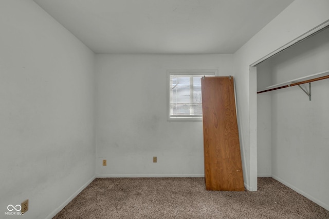 unfurnished bedroom with light colored carpet and a closet