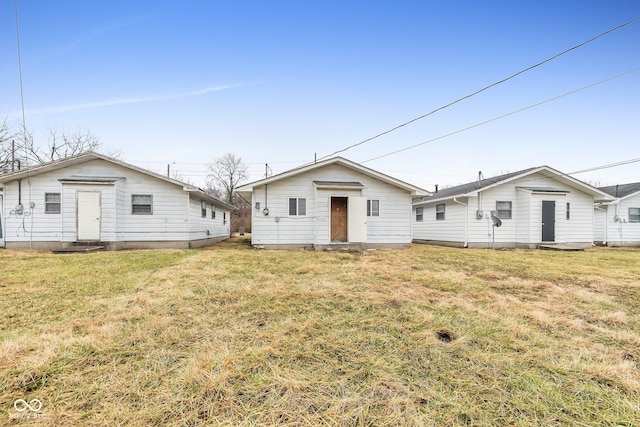 rear view of house with a yard