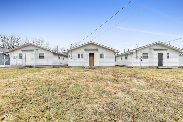 rear view of property featuring a yard