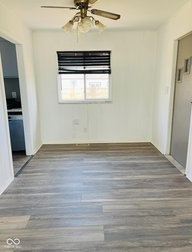 empty room with hardwood / wood-style floors and ceiling fan