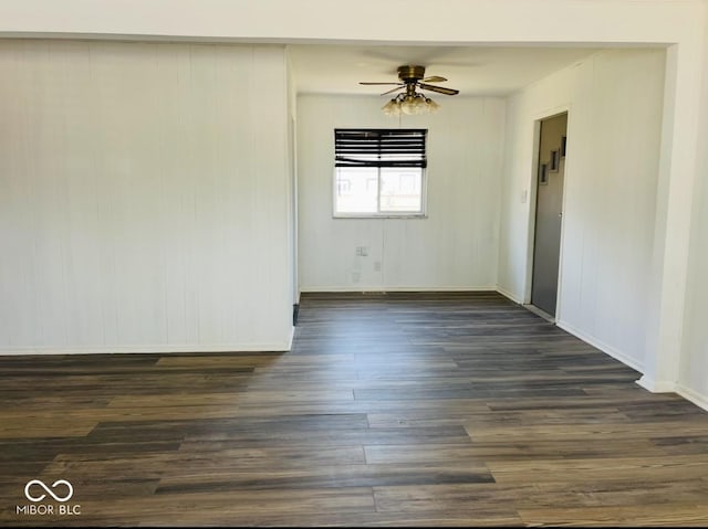 empty room with dark wood-type flooring and ceiling fan