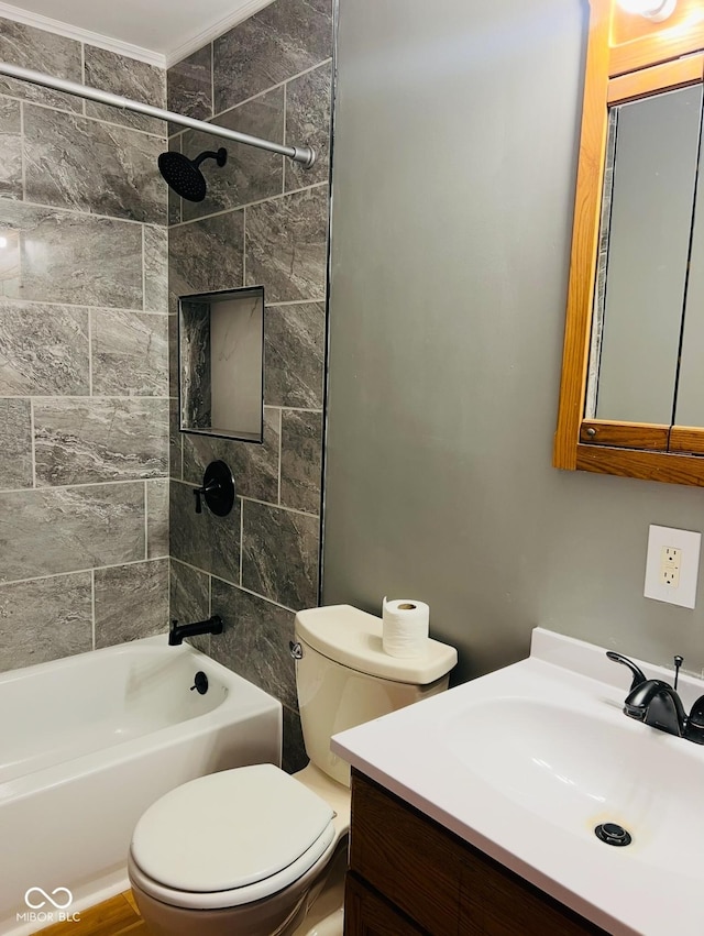 full bathroom featuring tiled shower / bath, vanity, and toilet