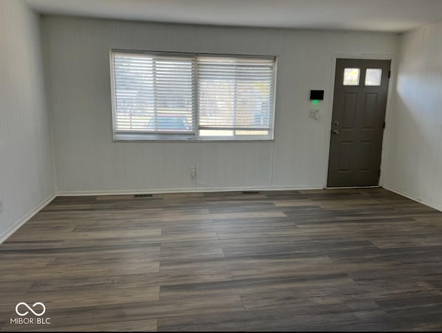 entryway with dark hardwood / wood-style flooring