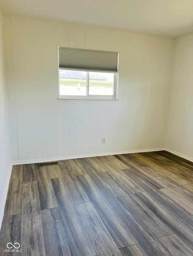 empty room with dark wood-type flooring