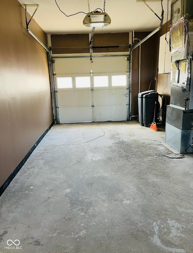 garage featuring heating unit and a garage door opener