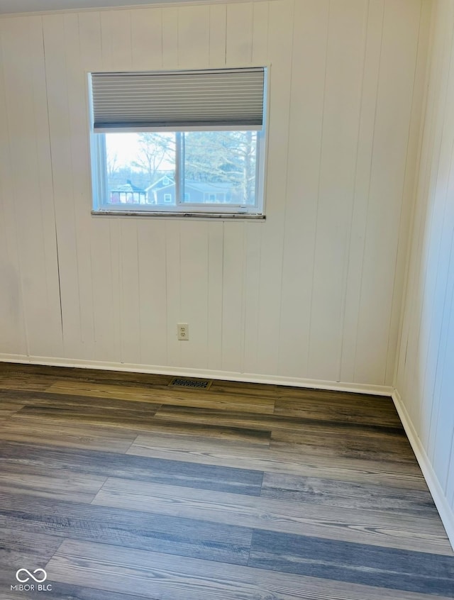 empty room featuring dark hardwood / wood-style flooring