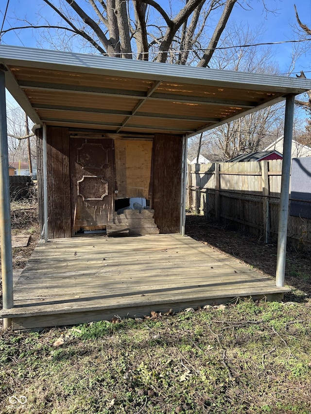 wooden deck featuring a storage unit