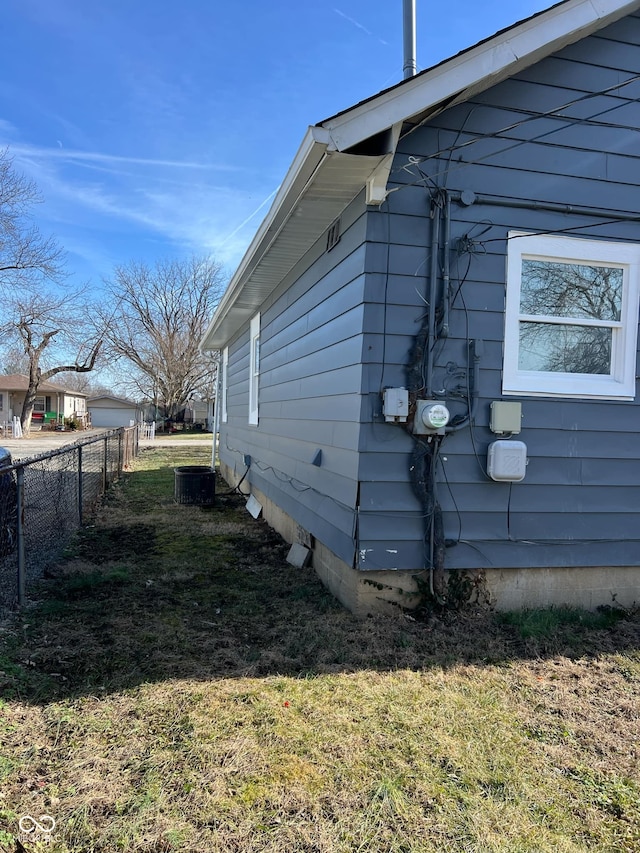 view of home's exterior with a yard and central air condition unit