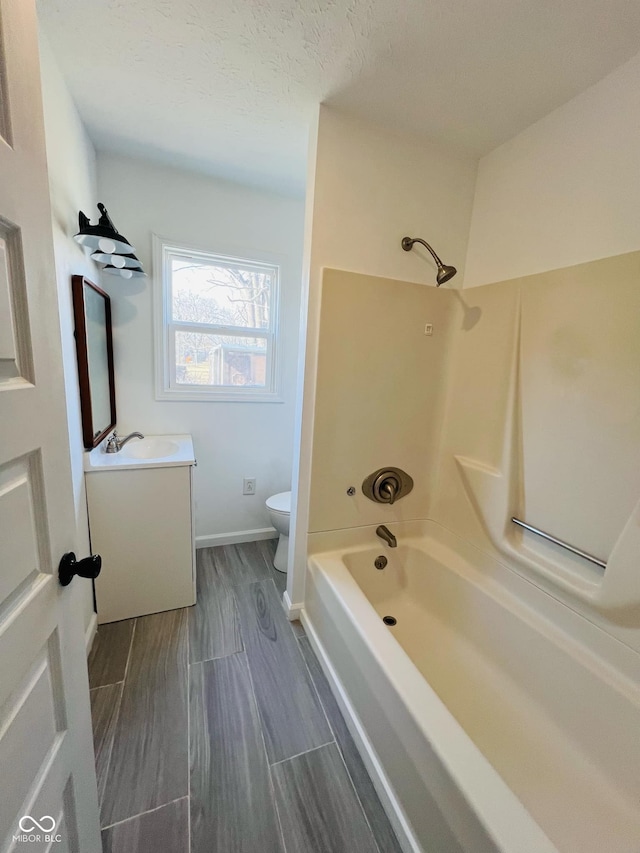 full bathroom with vanity, bathtub / shower combination, and toilet