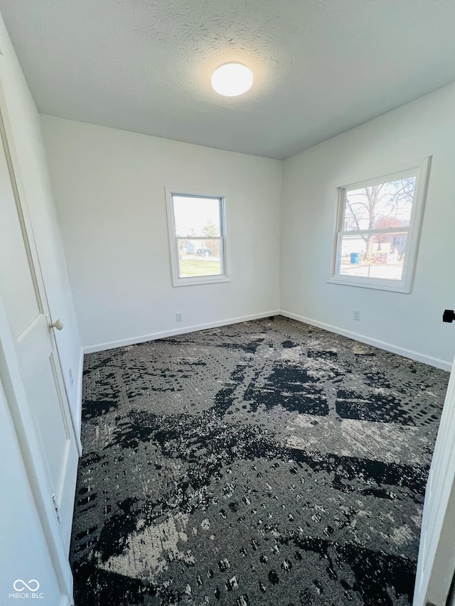 empty room with a textured ceiling