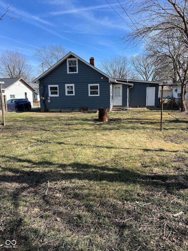 back of house with a yard