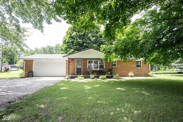 ranch-style home with a garage, covered porch, and a front lawn