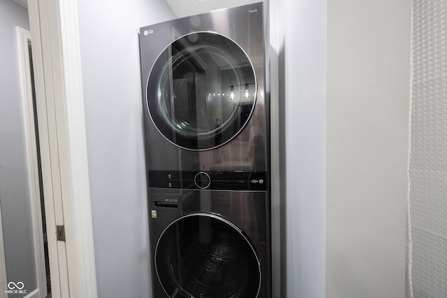 laundry room with stacked washer and dryer