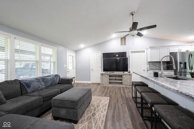 living room with dark hardwood / wood-style flooring, sink, lofted ceiling, and ceiling fan