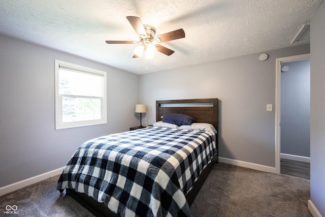 bedroom featuring dark carpet, a textured ceiling, and ceiling fan