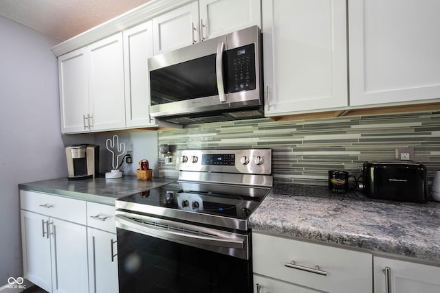 kitchen with white cabinetry, stainless steel appliances, and decorative backsplash