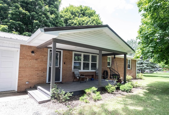 rear view of property with a porch and a lawn