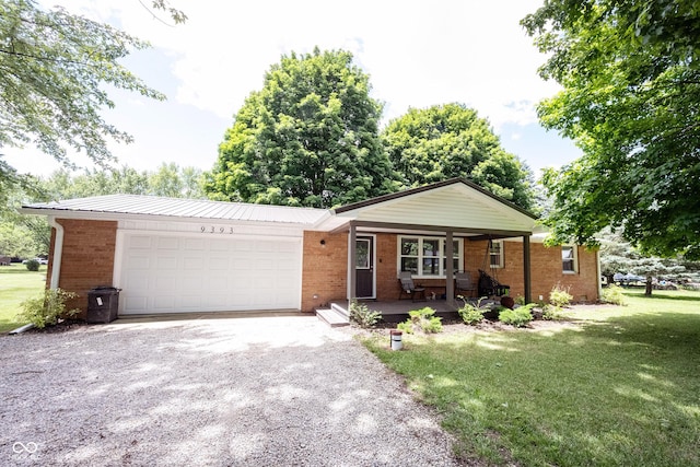 single story home with a garage, a front yard, and covered porch