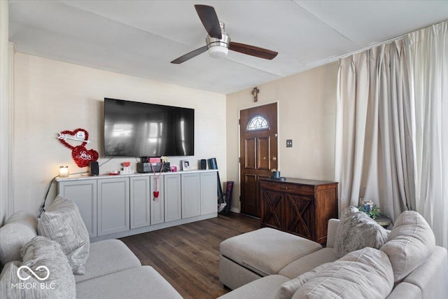 living room featuring ceiling fan and dark hardwood / wood-style floors