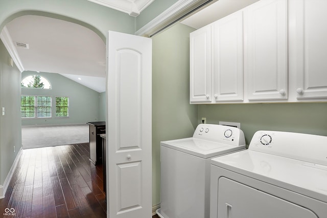 washroom with cabinet space, baseboards, visible vents, washer and clothes dryer, and dark wood finished floors