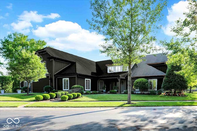 view of front of property with board and batten siding and a front lawn