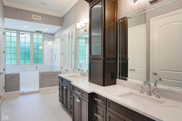 bathroom with crown molding, visible vents, a sink, and wallpapered walls