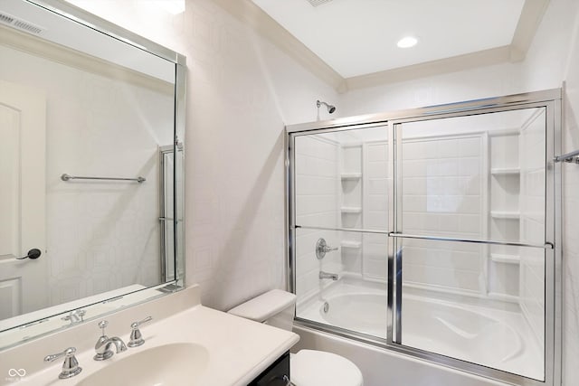 full bathroom with visible vents, vanity, toilet, and bath / shower combo with glass door