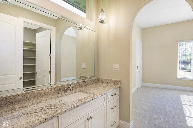 bathroom with baseboards and vanity