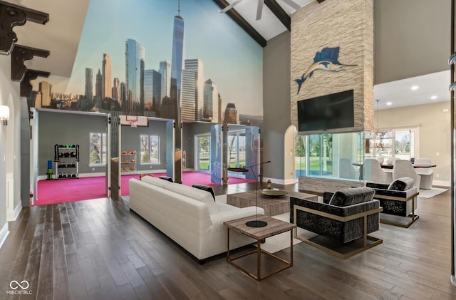 living area with high vaulted ceiling, beamed ceiling, wood finished floors, and baseboards