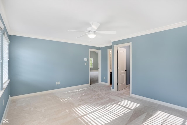 unfurnished bedroom with crown molding, carpet floors, and baseboards