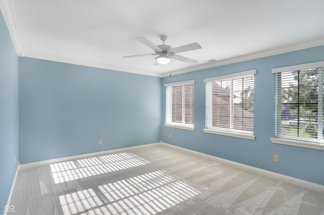 spare room featuring baseboards, visible vents, and crown molding