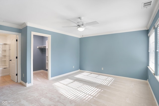 unfurnished bedroom featuring carpet floors, visible vents, and crown molding