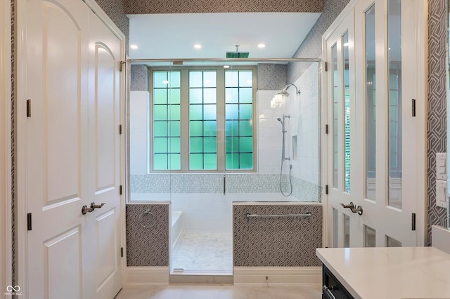 full bath with a shower stall and vanity