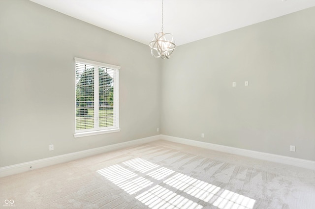 empty room featuring baseboards, a chandelier, and light colored carpet