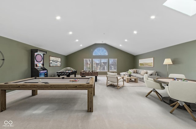 recreation room featuring vaulted ceiling with skylight, recessed lighting, and light colored carpet