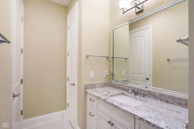 bathroom with tile patterned flooring, vanity, and baseboards