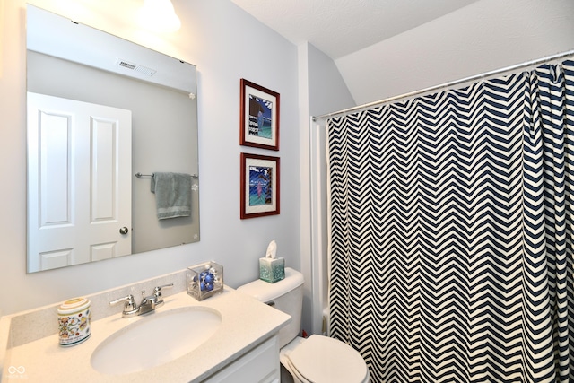 bathroom featuring vanity, curtained shower, and toilet