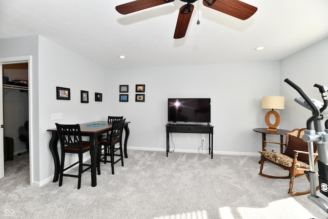 carpeted dining room with ceiling fan